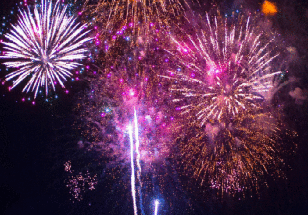 Colourful fireworks exploding in night sky celebration.
